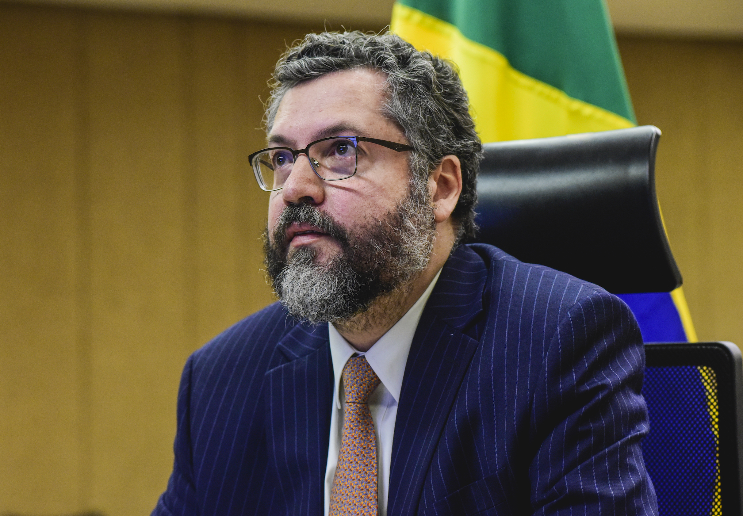 Ernesto Araújo, de terno, numa das salas do Itamaraty, durante conferência sobre a covid-19