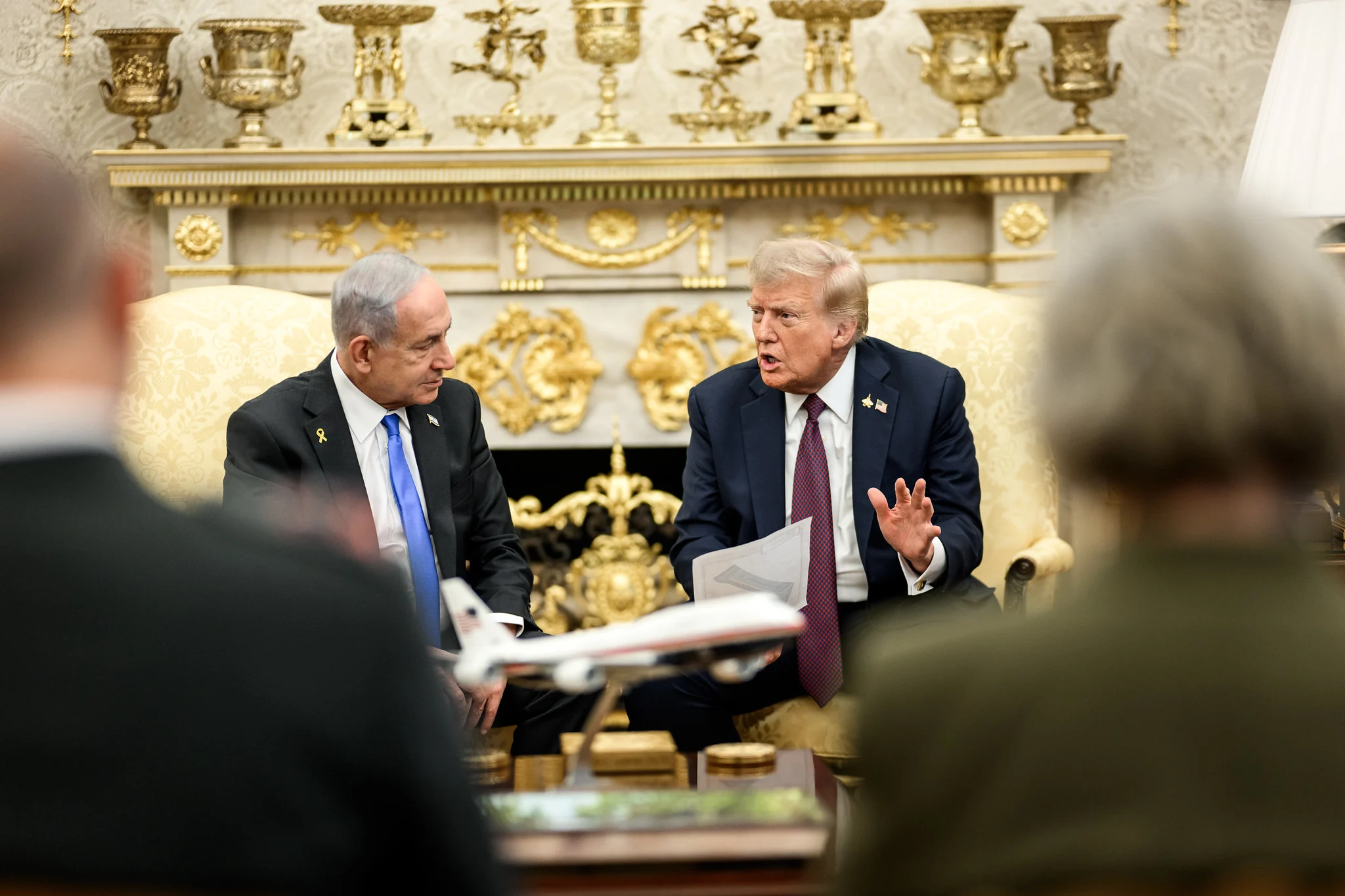 O primeiro-ministro de Israel, Benjamin Netanyahu, e o presidente dos EUA, Donald Trump, em reunião no Salão Oval da Casa Branca, em setembro de 2025. Dois homens estão de terno, sentados em poltronas. Um deles fala e segura um papel